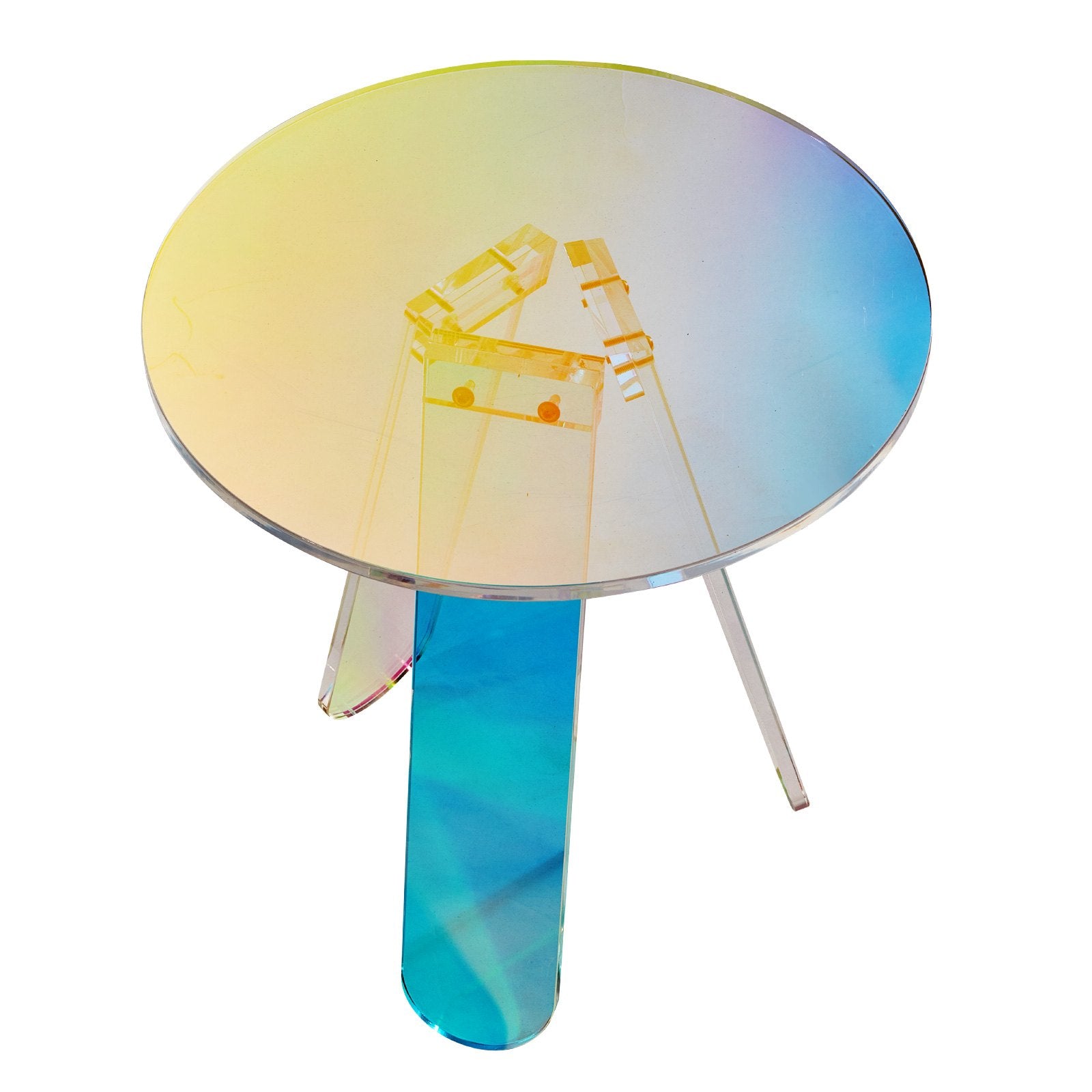 Round iridescent acrylic side table with three flat legs in pink and purple tones photographed from the side on a white