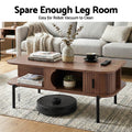 Walnut coffee table in living room, robot vacuum cleaning underneath, 22cm clearance, text: Spare Enough Leg Room