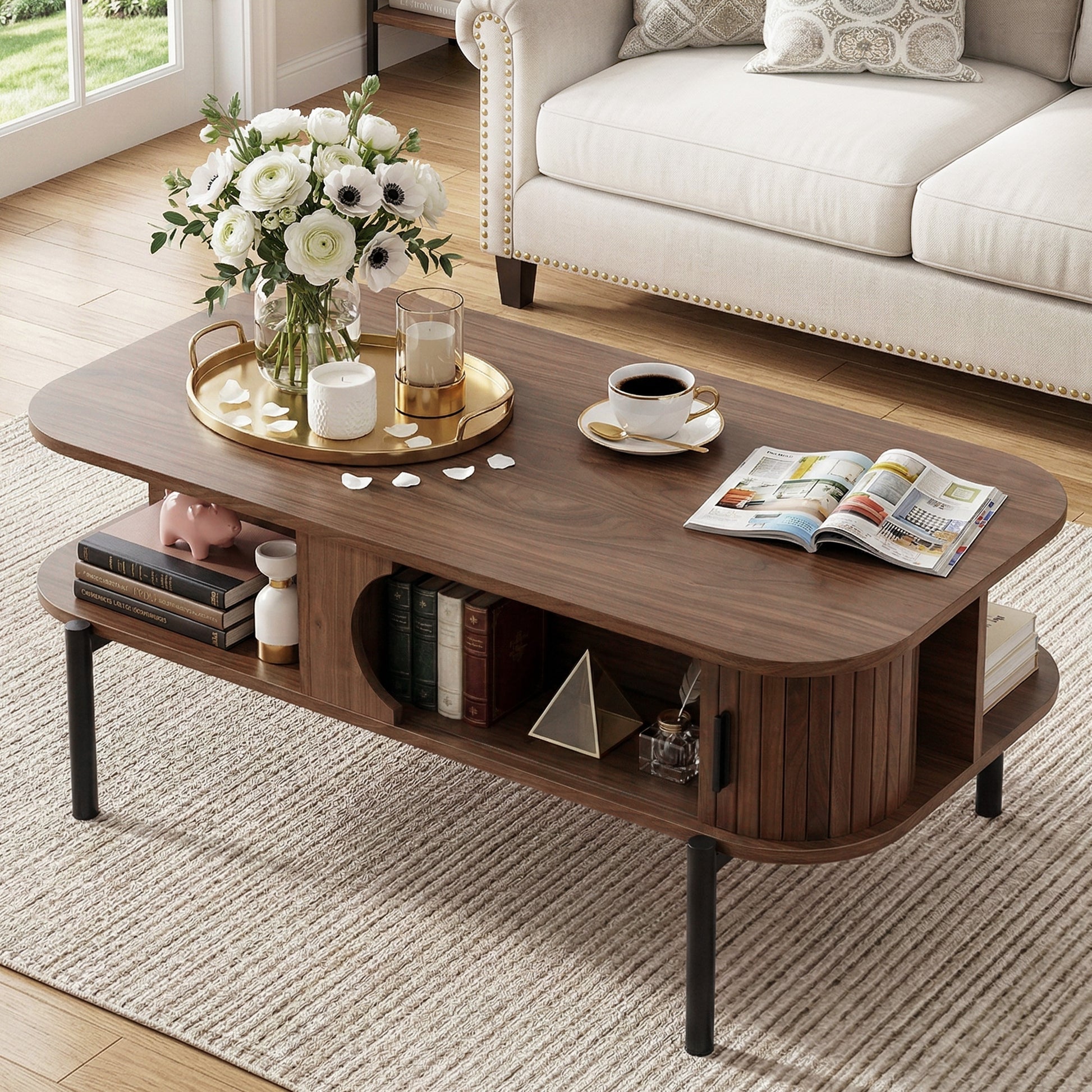 Walnut coffee table with rounded corners, open shelf below, styled with flowers and coffee cup in living room