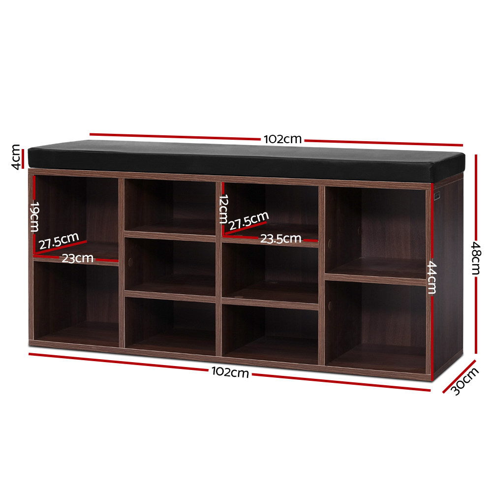 Walnut 10-cube shoe bench black cushion top all cubbies loaded with heels pumps sneakers on herringbone floor