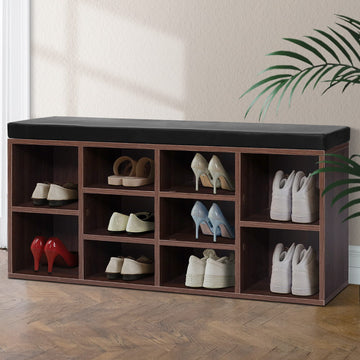 Walnut 10-cube shoe bench black cushion top all cubbies loaded with heels pumps sneakers on herringbone floor