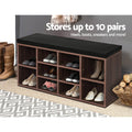 Walnut 10-cube shoe bench in grey room with boots on floor beside bench and 10 cubbies loaded with shoes