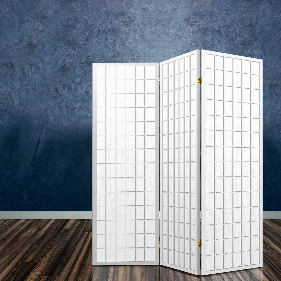 White 3-panel fabric grid shoji room divider in lifestyle room with blue textured concrete wall and dark wood floor
