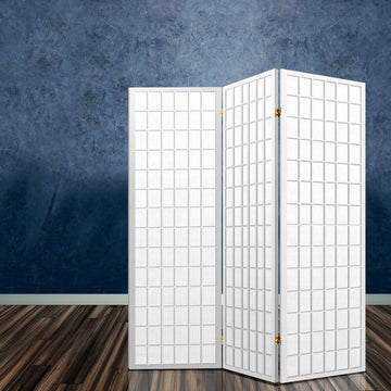 White 3-panel fabric grid shoji room divider in lifestyle room with blue textured concrete wall and dark wood floor