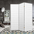 White 3-panel fabric grid shoji room divider in grey concrete lifestyle studio with tripod floor lamp and geometric rug