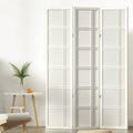 White 3-panel double crosshatch shoji room divider in lifestyle room with fern plant orange on round side table