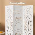White 3-panel mandala cutout room divider curved pattern close-up in boho lifestyle room with oranges on round table