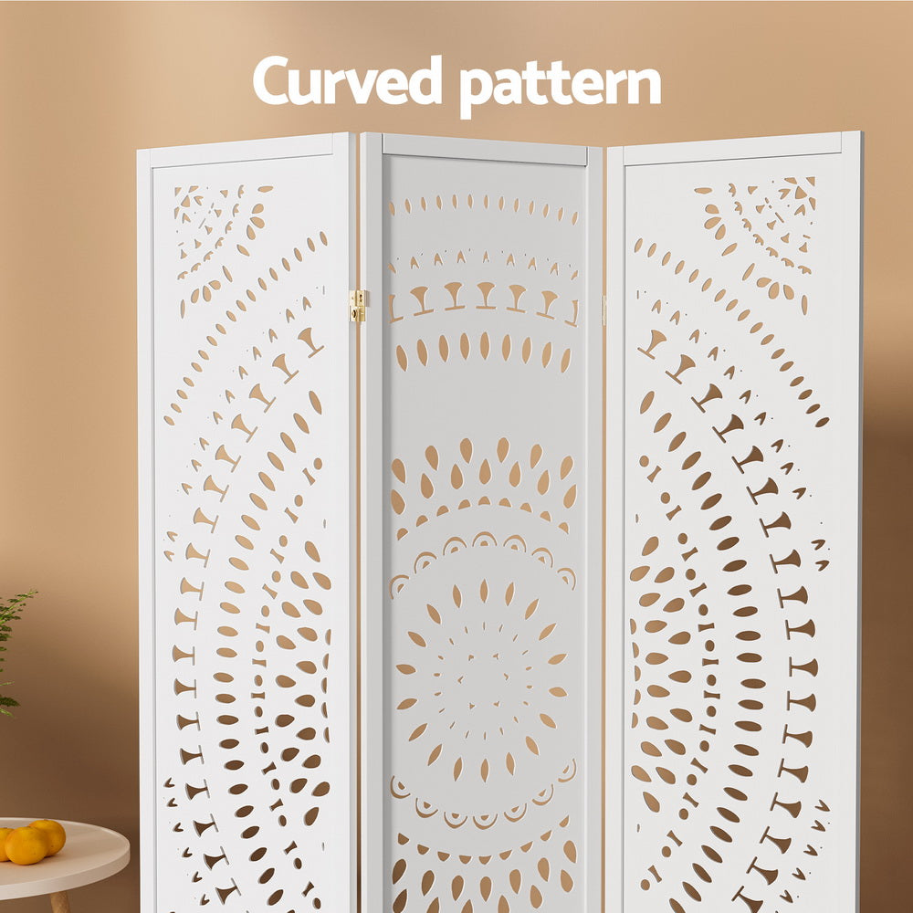 White 3-panel mandala cutout room divider curved pattern close-up in boho lifestyle room with oranges on round table