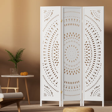 White 3-panel mandala cutout MDF room divider in boho lifestyle room with round wooden table plant and oranges