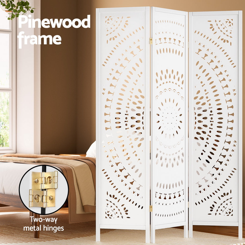 White 3-panel mandala cutout room divider in bedroom lifestyle with pinewood frame and two-way gold metal hinges callout