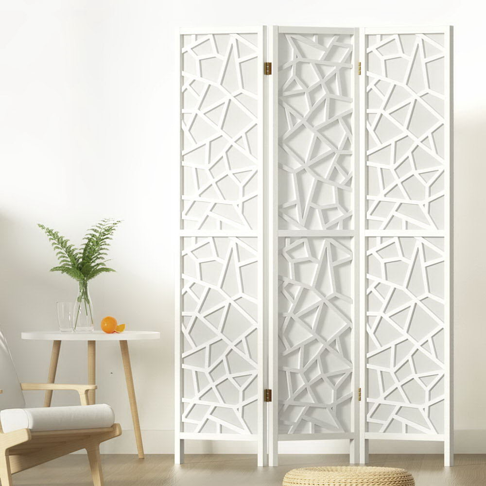 White 3-panel MDF star cutout room divider in lifestyle room with fern plant orange round table armchair and floor cushion