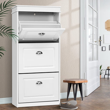 White three-tier flip-out shoe cabinet top compartment open two lower doors closed in hallway with wooden stool and shoe