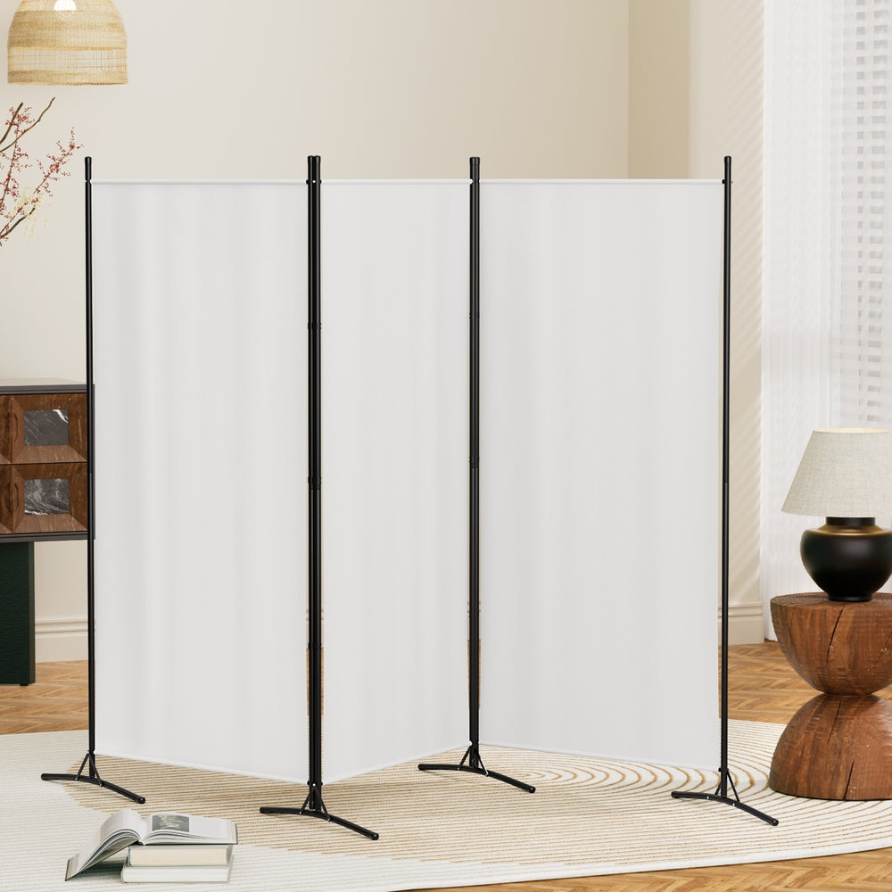 White 4-panel fabric room divider in living room lifestyle with woven pendant blossoming branch and lamp on sideboard