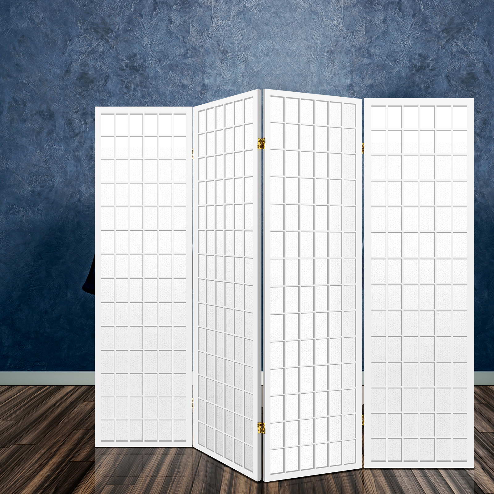 White 4-panel fabric grid shoji room divider angled view in lifestyle with blue textured concrete wall and dark wood floor