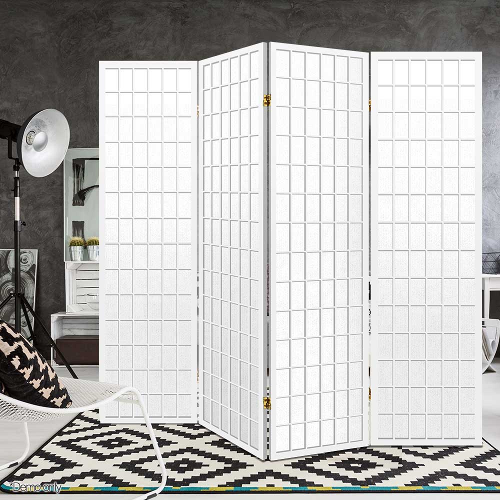 White 4-panel fabric grid shoji room divider in grey concrete lifestyle studio with tripod floor lamp and geometric rug
