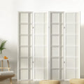 White 4-panel double crosshatch grid shoji room divider in lifestyle room with fern plant orange and floor cushion