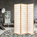 White 4-panel louvered wood room divider with built-in shelves in lifestyle room with papasan chair plant and vase