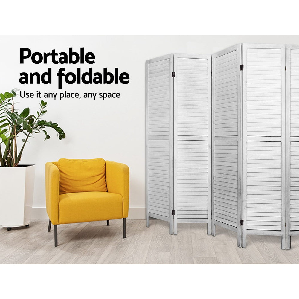 White 4-panel louvered wood room divider in living room lifestyle with yellow armchair and ZZ plant against white wall
