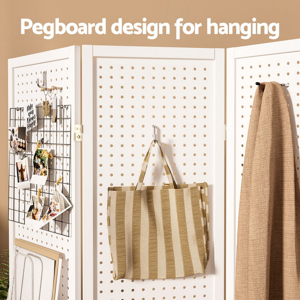 White 4-panel pegboard room divider hanging design close-up with hooks holding tote bag and scarf and wire grid panel