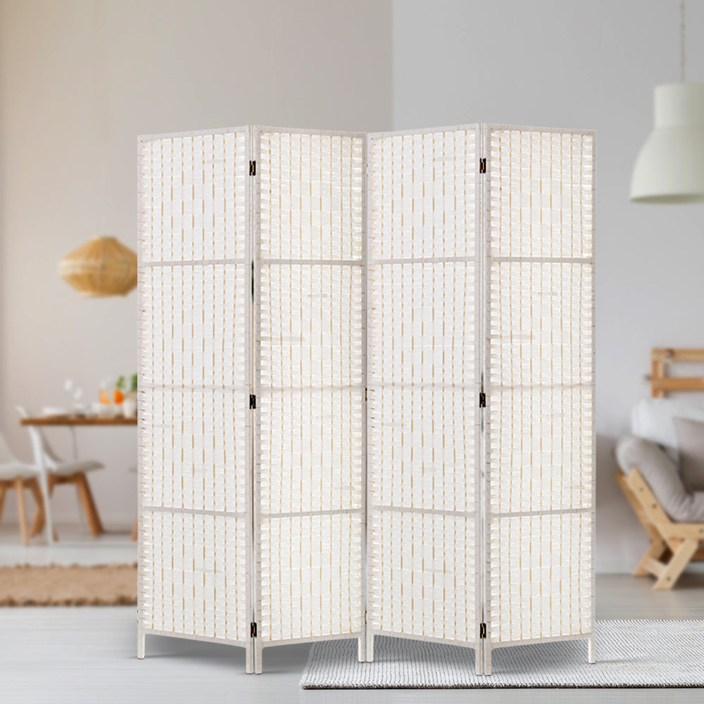 White 4-panel woven paper rope room divider in Scandinavian room with rattan pendant lamp wood dining table and decor shelf