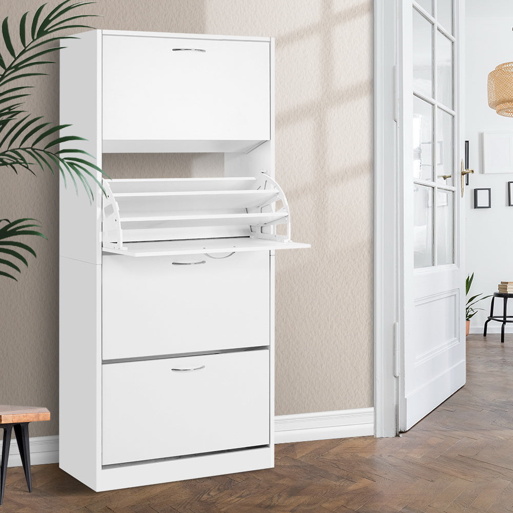 White four-tier flip-out shoe cabinet second compartment tray open in hallway with wooden stool palm plant and French door