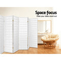 White 6-panel fabric grid room divider in lifestyle room with papasan rattan chair and wood dressing table vanity