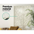 White 6-panel geometric room divider non-woven fabric panel close-up in lifestyle room with palm plant and yellow sofa