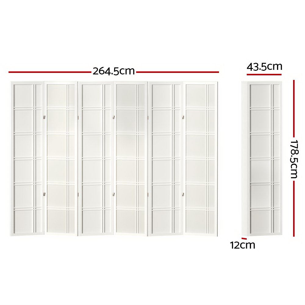 White 6-panel grid pattern shoji room divider in lifestyle room against white wall with wooden chair and floor cushion