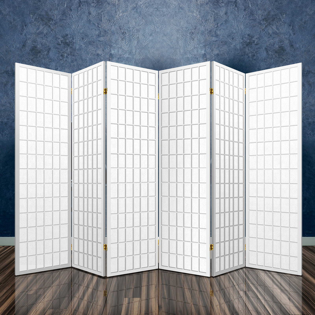White 6-panel grid shoji room divider in room with dark stone textured wall reflective floor and brass hinges