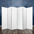 White 6-panel grid shoji room divider in room with dark stone textured wall reflective floor and brass hinges