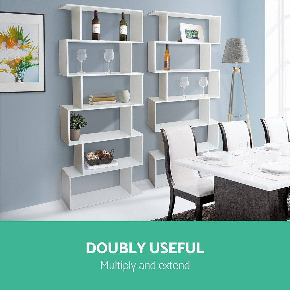 Two white S-shaped bookcases in dining room beside white dining table, text reads Doubly Useful