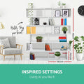 White S-shaped bookcase in living room with dimensions overlay: 192cm tall, 80cm wide, holds 3kg per shelf