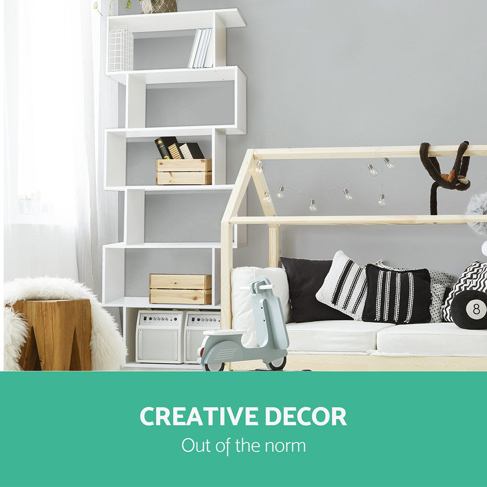 White S-shaped bookcase in children's bedroom beside house-frame bed, text reads Creative Decor