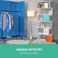 White S-shaped bookcase in room with blue room divider and clothes rack, text reads Unique Artistry