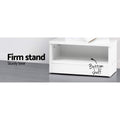 Close-up of white tree bookcase sturdy base with open bottom shelf, text reads Firm stand, sturdy base