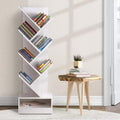 White 7-tier tree-shaped bookcase filled with colourful books beside small wooden side table in bright room
