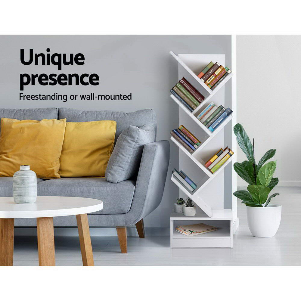 White 7-tier tree-shaped bookcase with books in living room beside grey sofa, text reads Unique presence