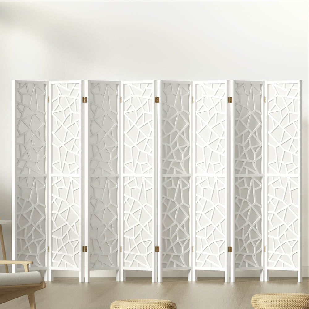 White 8-panel MDF room divider with geometric star pattern cutouts in lifestyle room with chair and ottomans