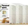White 8-panel geometric MDF room divider personal space lifestyle with pine bed and two-way gold metal hinges callout