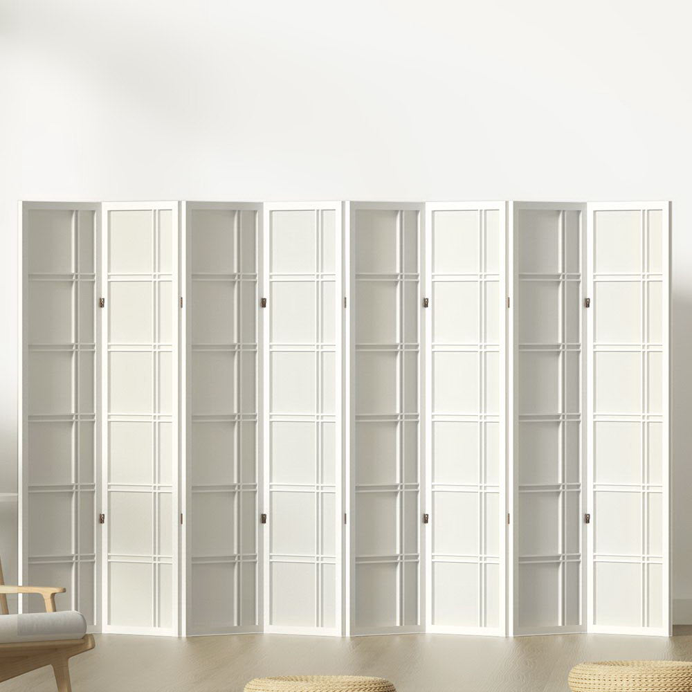 White 8-panel grid pattern shoji room divider in lifestyle room against white wall with chair and floor cushions