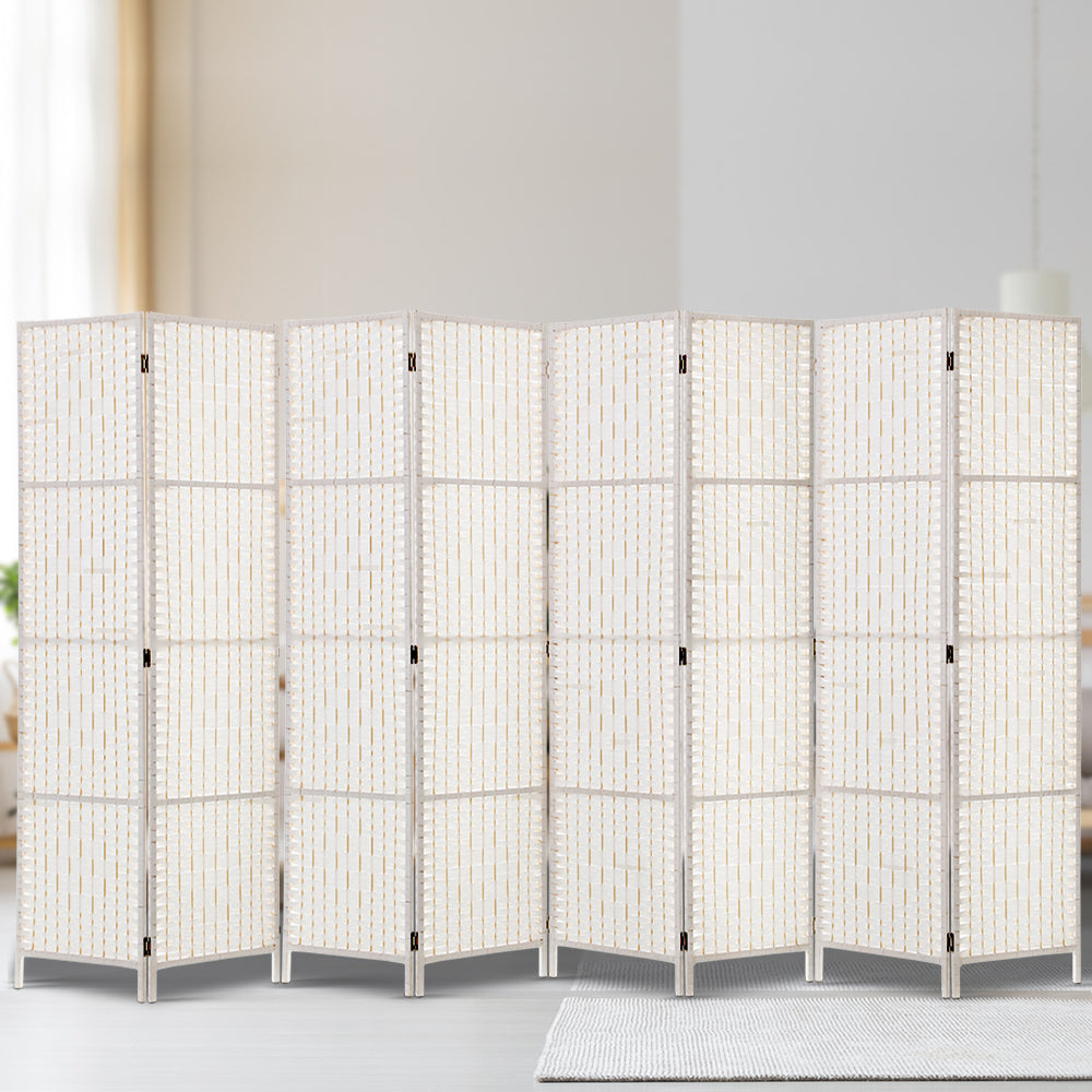 White 8-panel woven paper rope room divider in neutral lifestyle room with silver hinges and white wood frame on cream rug