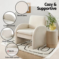 White boucle armchair in room with feature callouts: boucle fabric, curved armrest, plush support, 10cm cushion depth