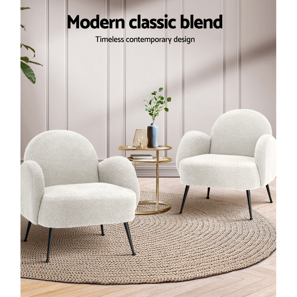 Two white boucle armchairs facing each other with gold side table on jute rug, "Modern classic blend" text