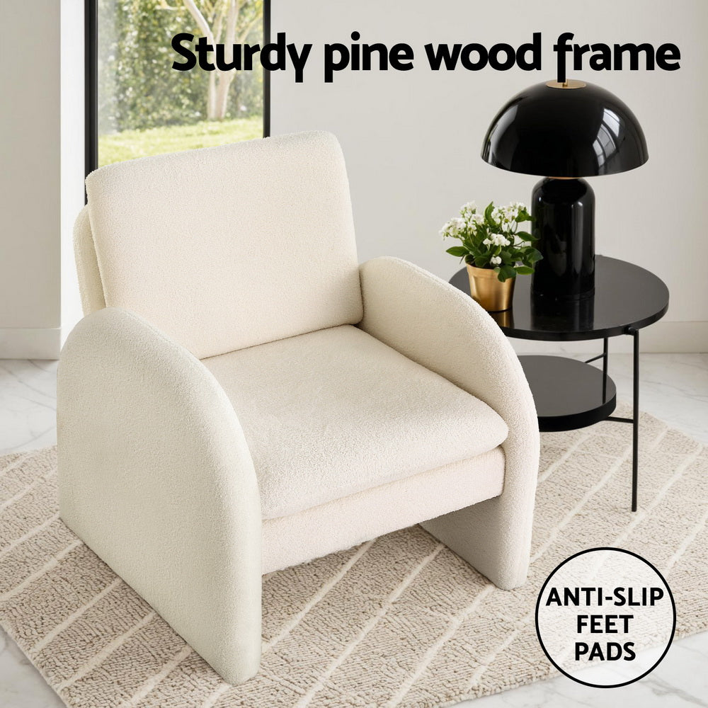 White boucle arch armchair on rug with black side table, "Sturdy pine wood frame" text, anti-slip feet pads badge