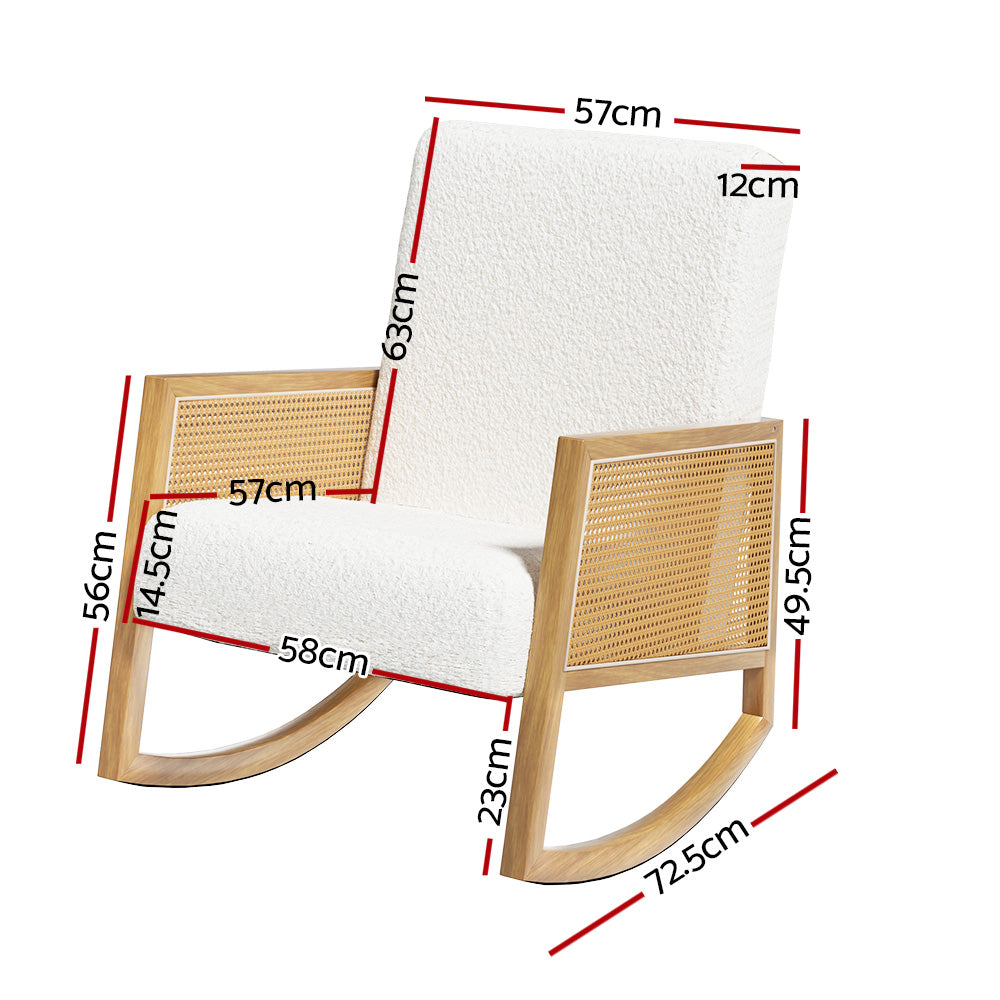 White boucle rocking chair with rattan cane armrests and natural wood frame, in room with rattan pendant lamp and side table