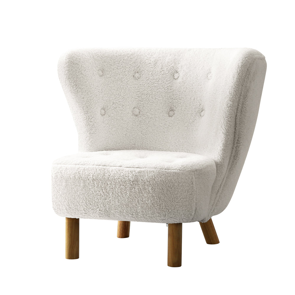 White boucle button-tufted wingback accent chair with natural wood cylindrical legs, angle view on white background