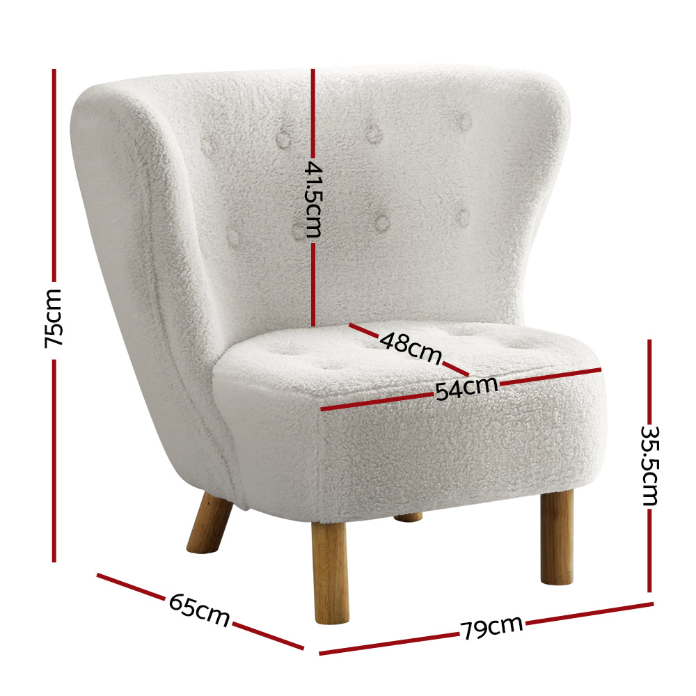 White boucle button-tufted wingback accent chair with natural wood cylindrical legs in living room near window