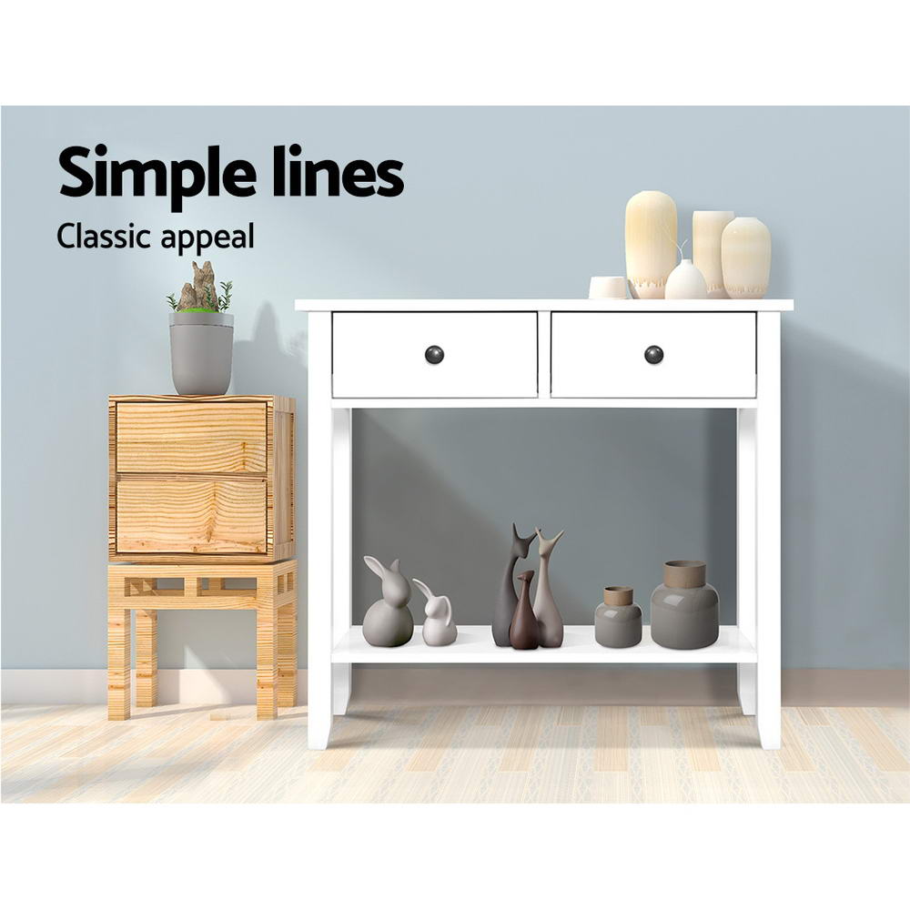 White console table with two drawers styled in room: ceramic figurines on lower shelf, vases on top; text "Simple lines"