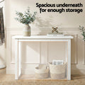 White console table in hallway with open lower shelf and wicker baskets, text 