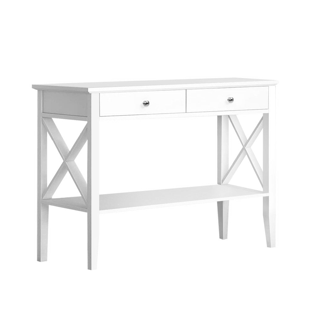 White console table front view: two drawers with chrome knobs, X-frame sides, lower shelf and tapered legs, white background